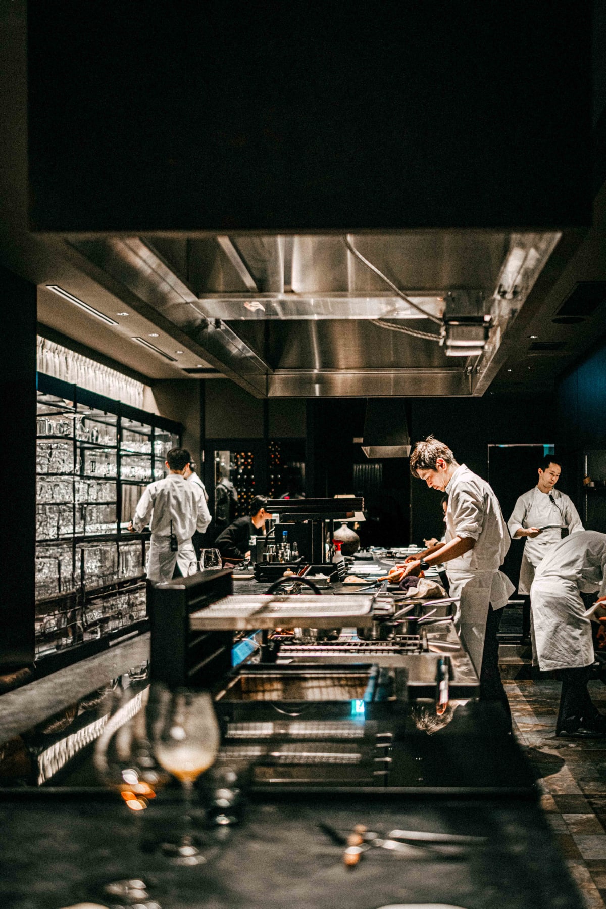 Florilège, Tokyo: the open kitchen during service, chefs working along the pass