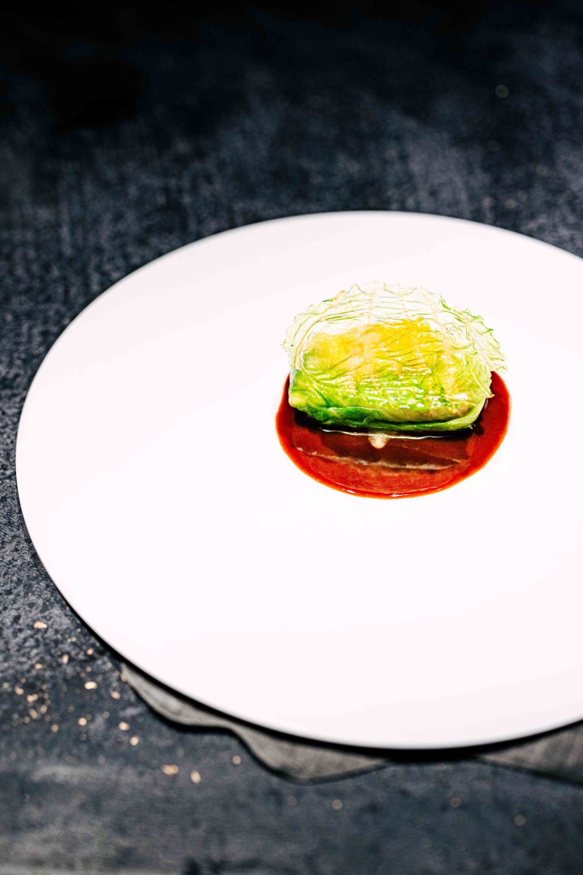 Florilège, Tokyo: moroko wrapped in cabbage under a translucent cabbage chip, on a dark red wine sauce