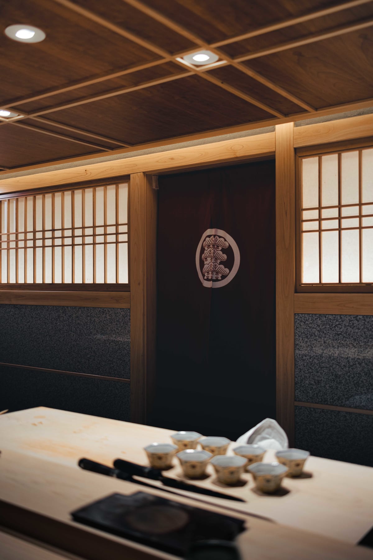 Sushi Juyon by Saito, Seoul: the counter before service, shoji windows behind it, glasses and knives set at each place