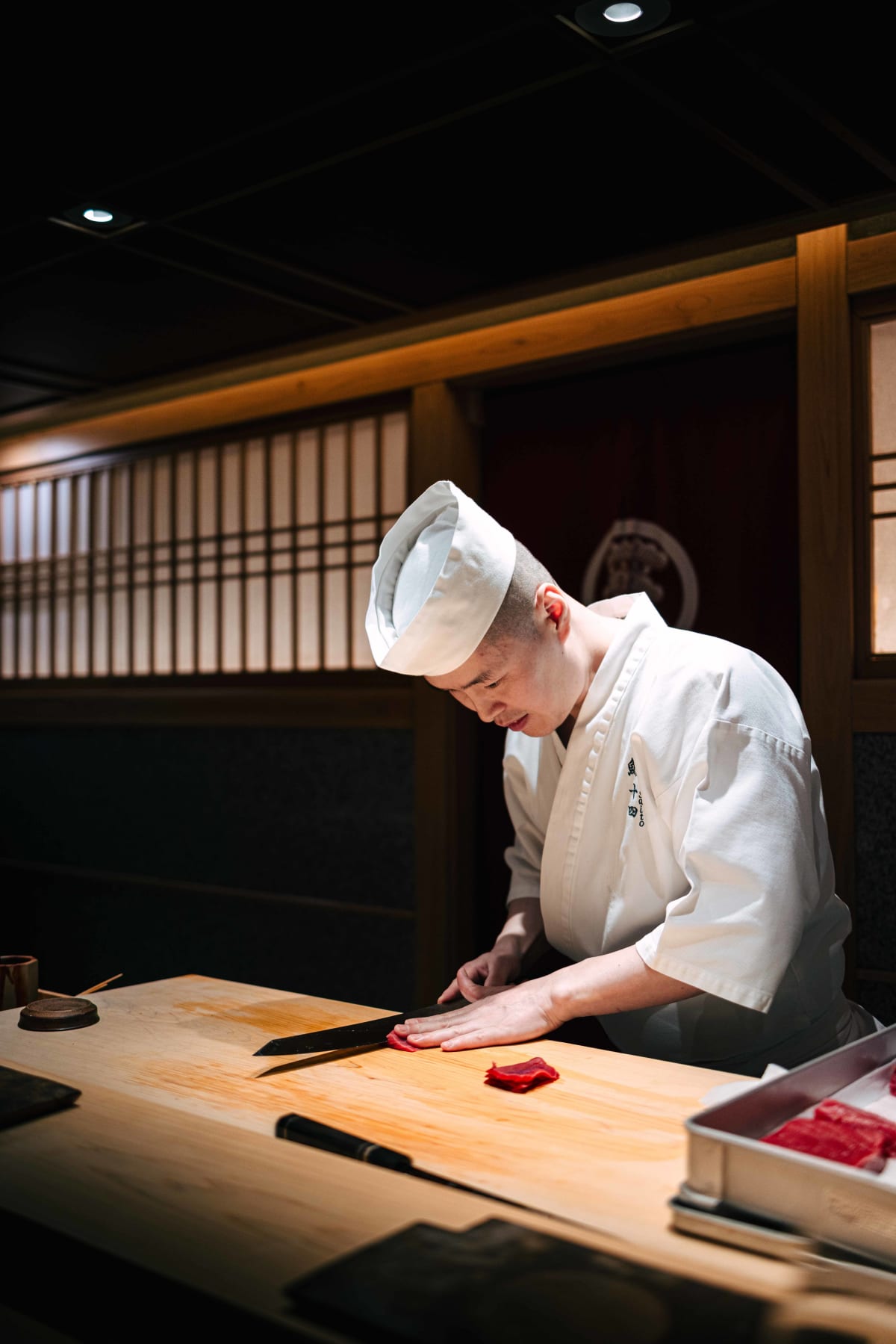Sushi Juyon by Saito, Seoul: the taisho cutting akami, a tray of tuna beside him