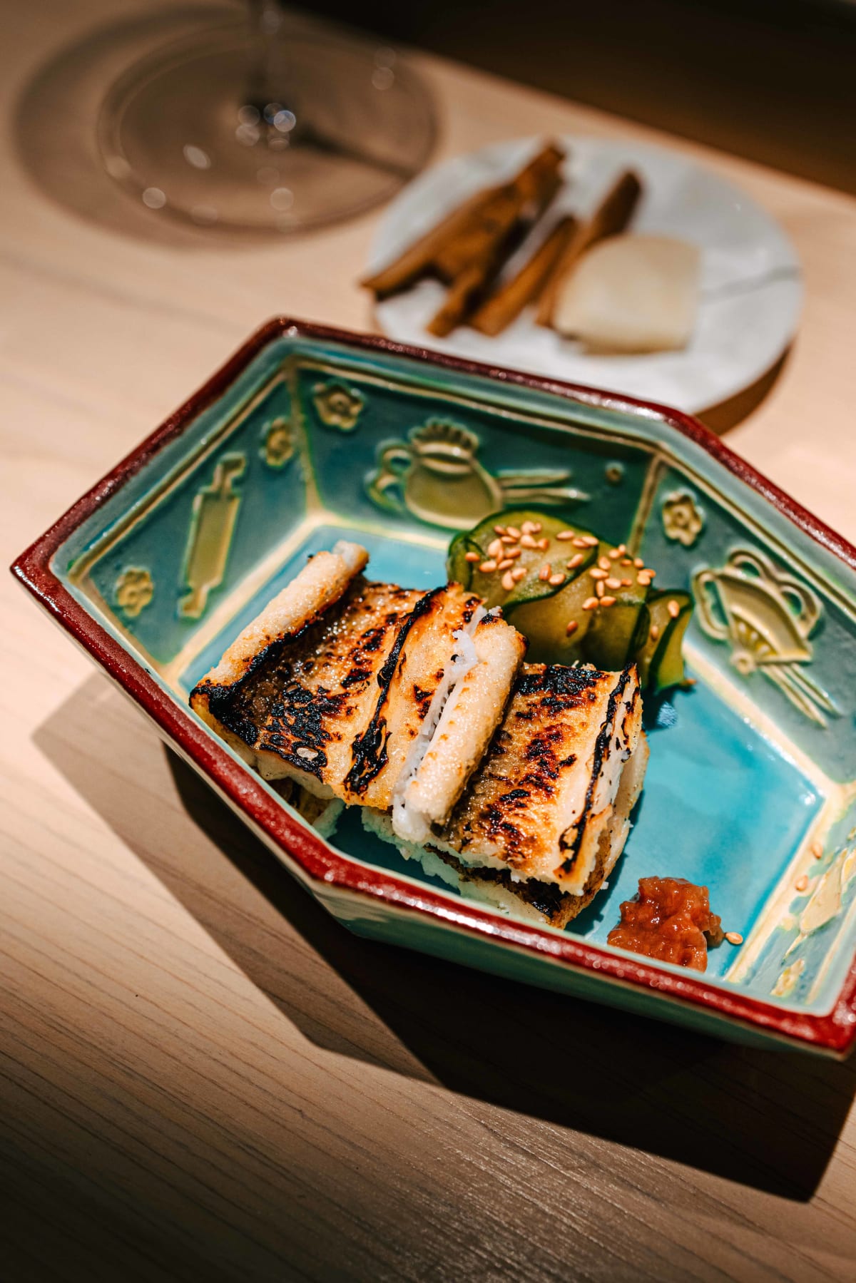 Sushi Juyon by Saito, Seoul: the anago shirayaki up close, grill marks on the conger eel and the umeboshi beside it