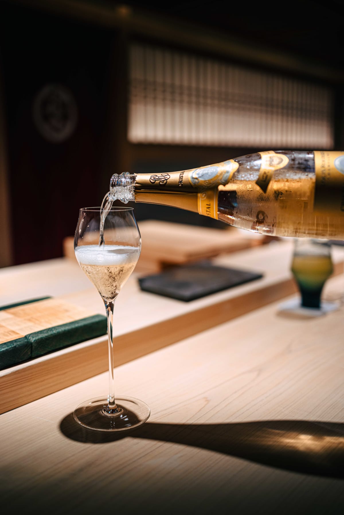 Sushi Juyon by Saito, Seoul: the Cristal being poured, the crested noren behind