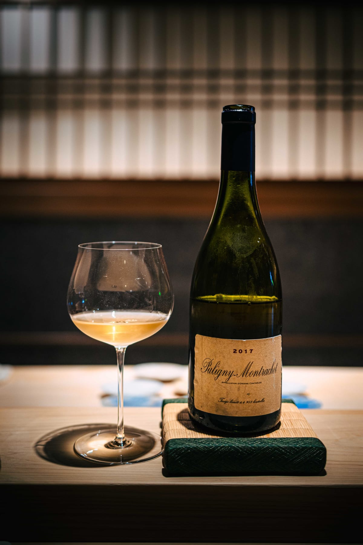 Sushi Juyon by Saito, Seoul: a bottle of Domaine de la Vougeraie Puligny-Montrachet 2017, its label noting a limited run of 4,958 bottles, beside a glass