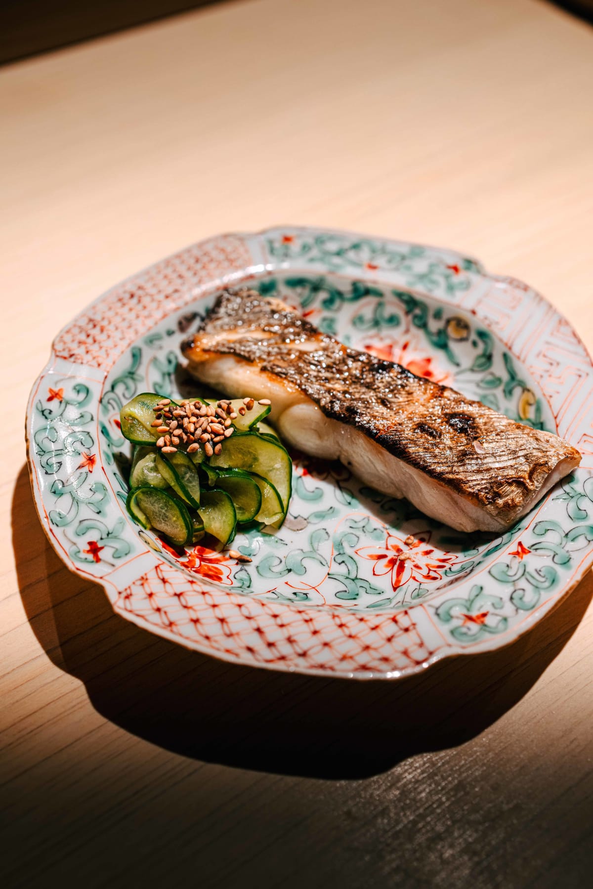 Sushi Juyon by Saito, Seoul: grilled hairtail with pickled cucumber and sesame on a painted plate