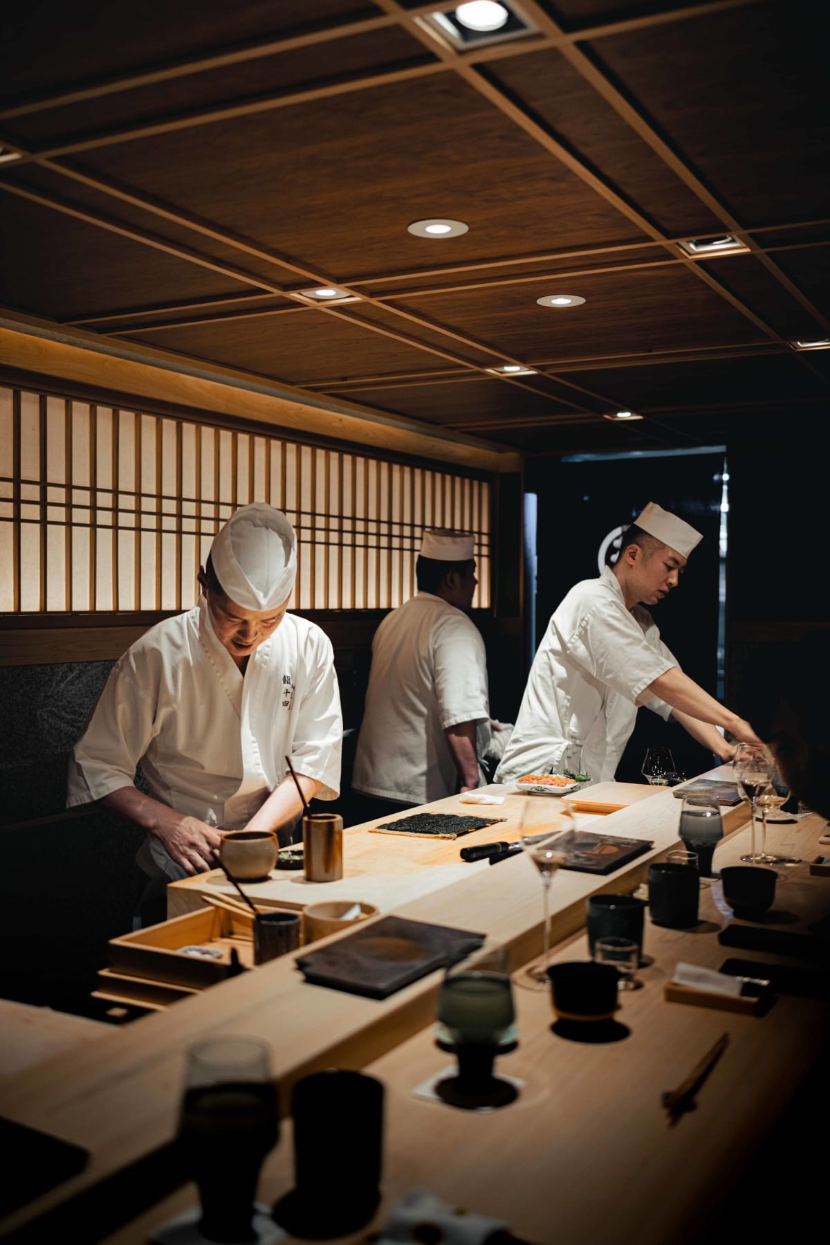 Sushi Juyon by Saito, Seoul: the taisho and two cooks standing together behind the counter at the end of the night