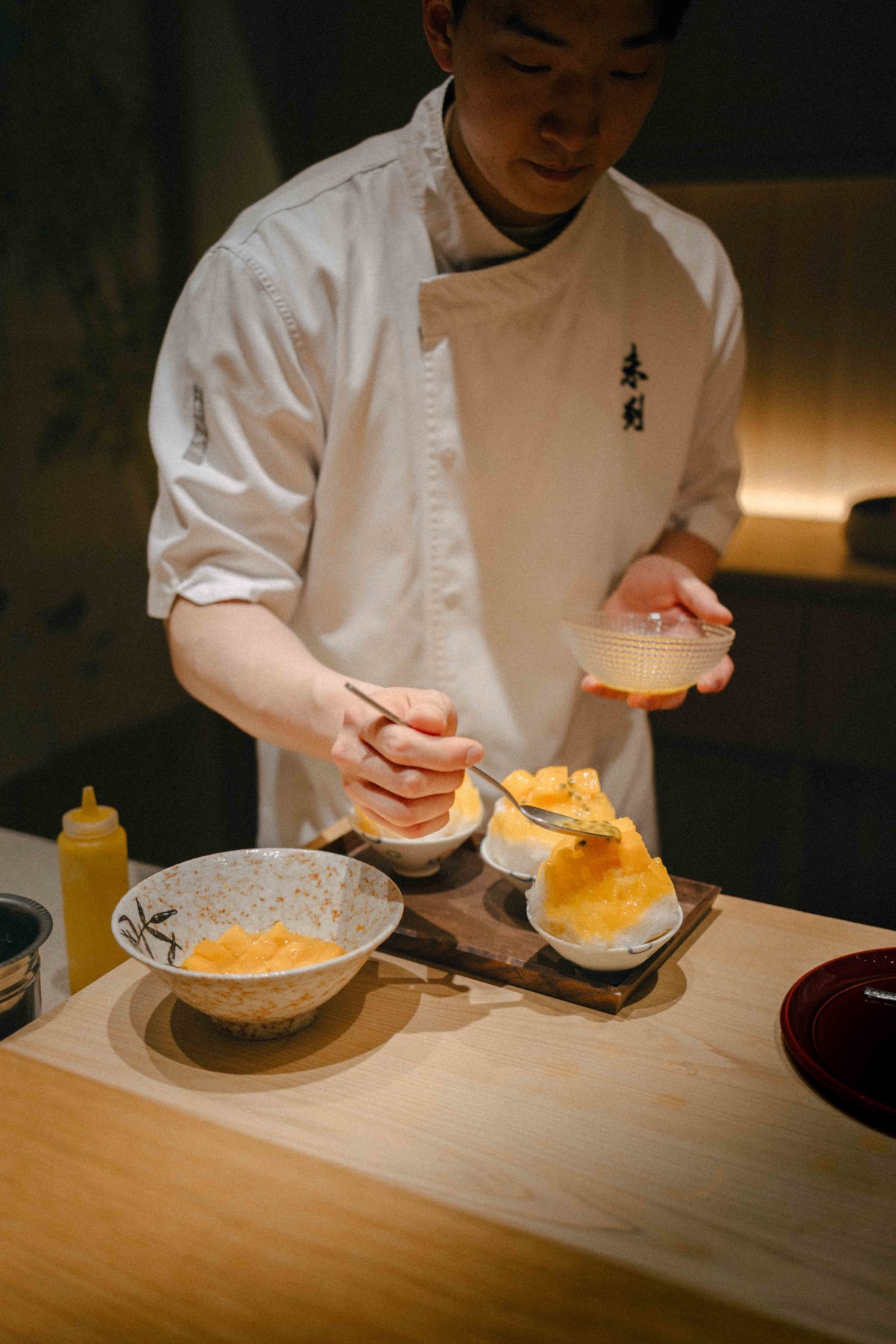 Mitou, Seoul: a cook topping the kakigori with passion fruit