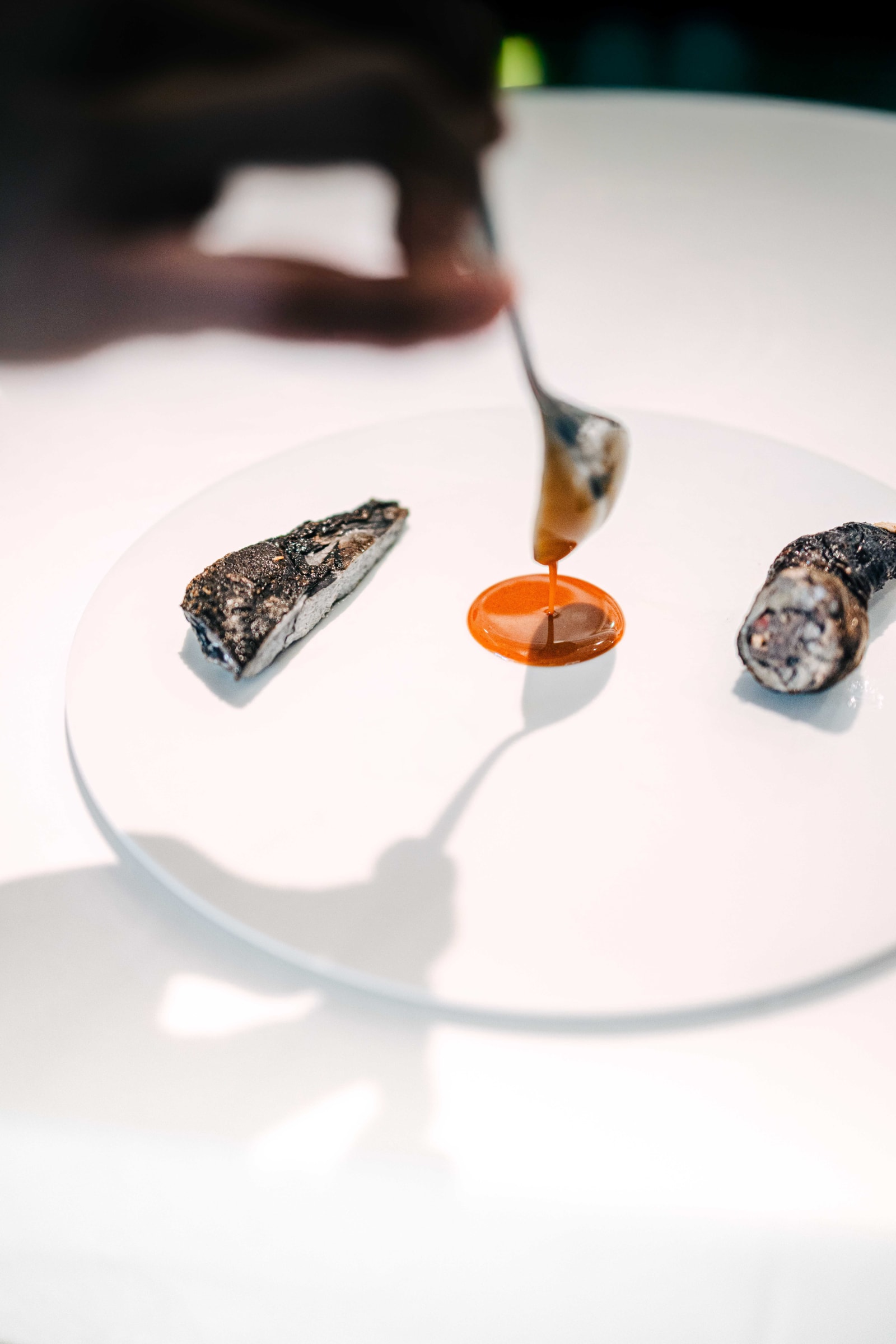 JEE, Hong Kong: the Moutai sauce spooned onto the plate between the silkie chicken breast and the stuffed leg
