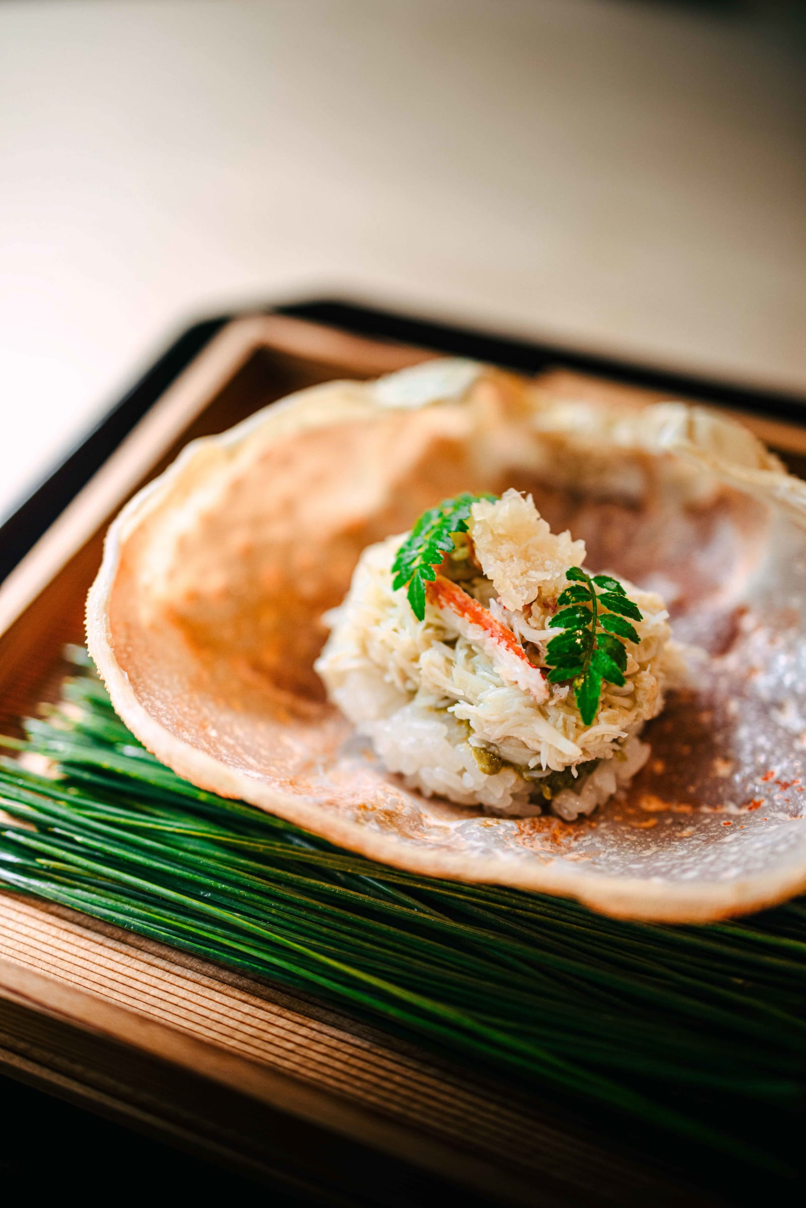 Matsukawa, Tokyo: snow crab and shari packed into the crab's own shell, a sprig of kinome on top