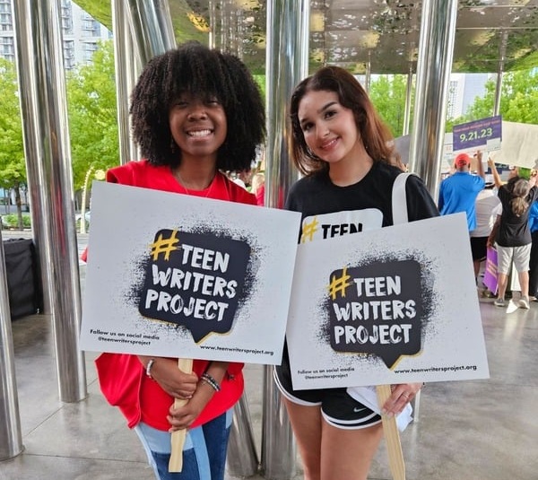 Teen Writers Project teens holding signs
