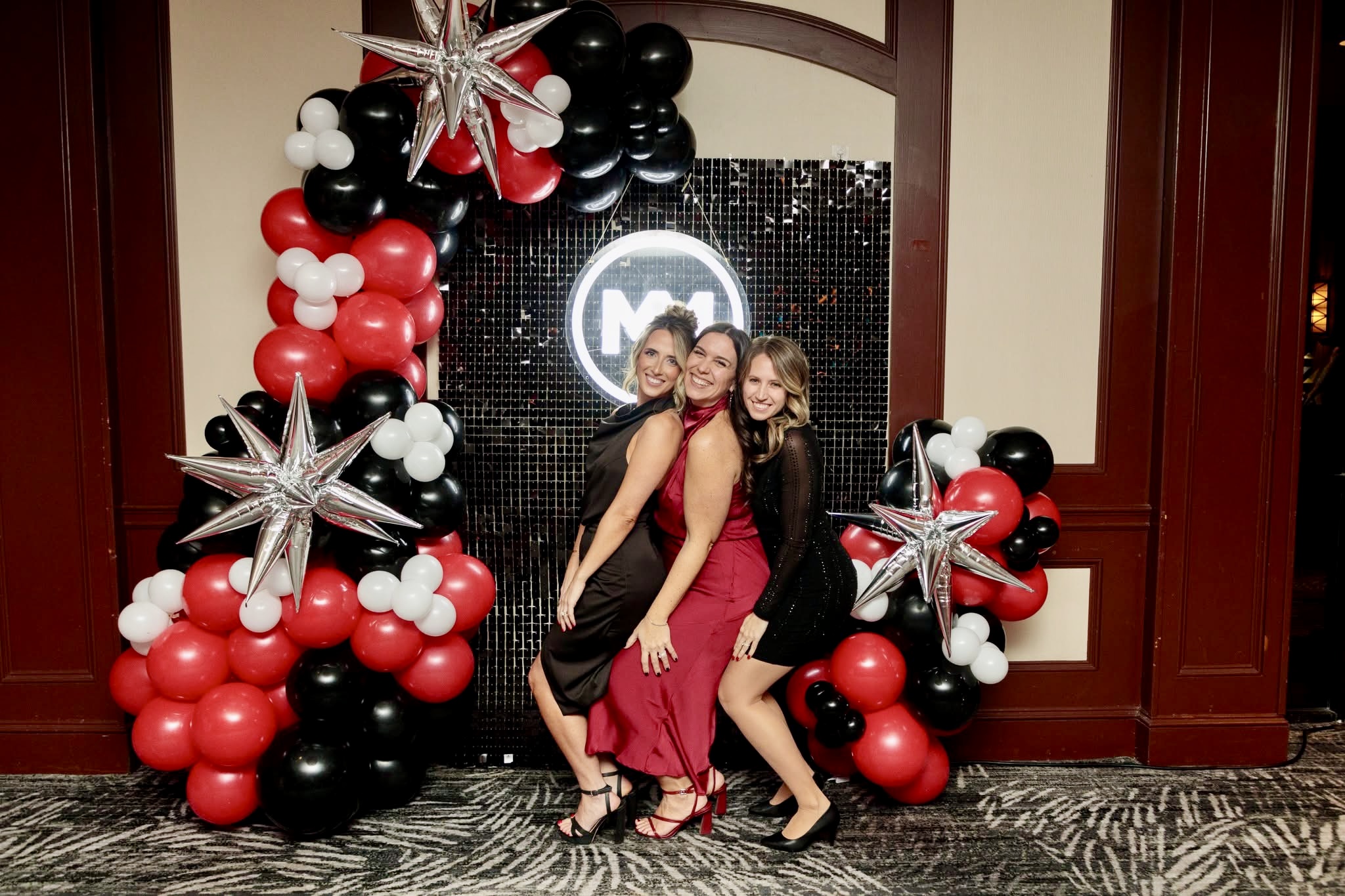 Red, black and silver balloon arch and photo wall at a Pittsburgh corporate gala by Party on Butler