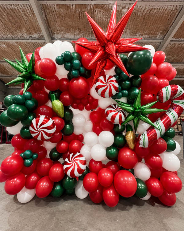Red, green and white Christmas balloon backdrop in Pittsburgh by Party on Butler