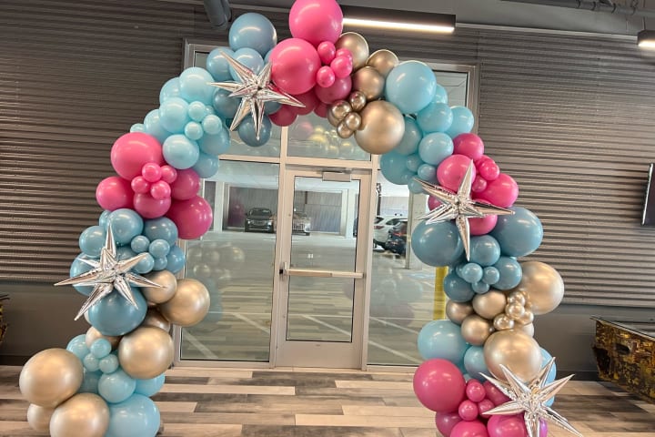 Grand balloon arch framing a Pittsburgh event by Party on Butler