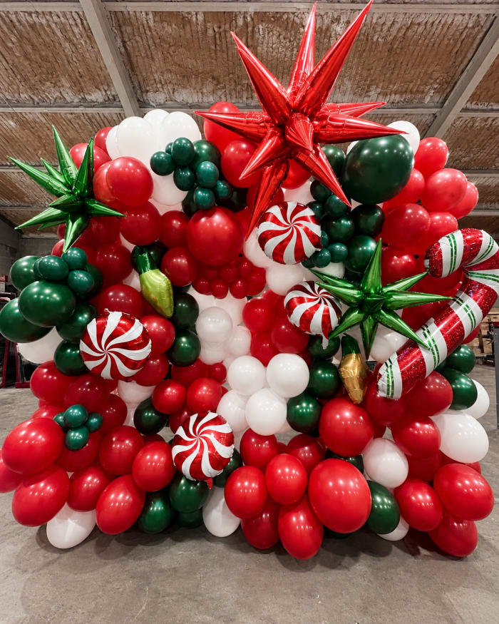 Red, green and white Christmas balloon backdrop in Pittsburgh by Party on Butler