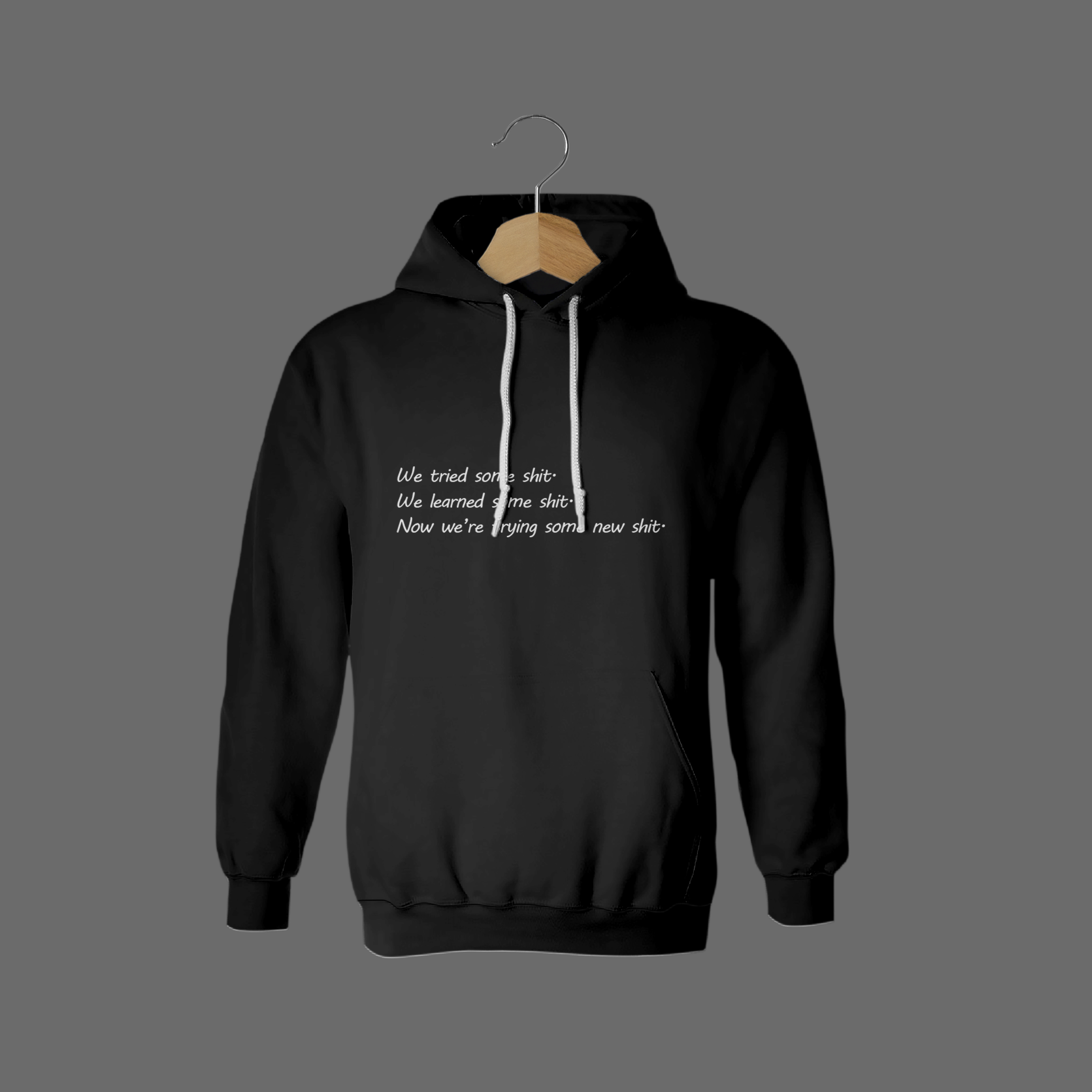 Front of tote bag with washed black canvas body, black straps, and tan leather handles and accents.