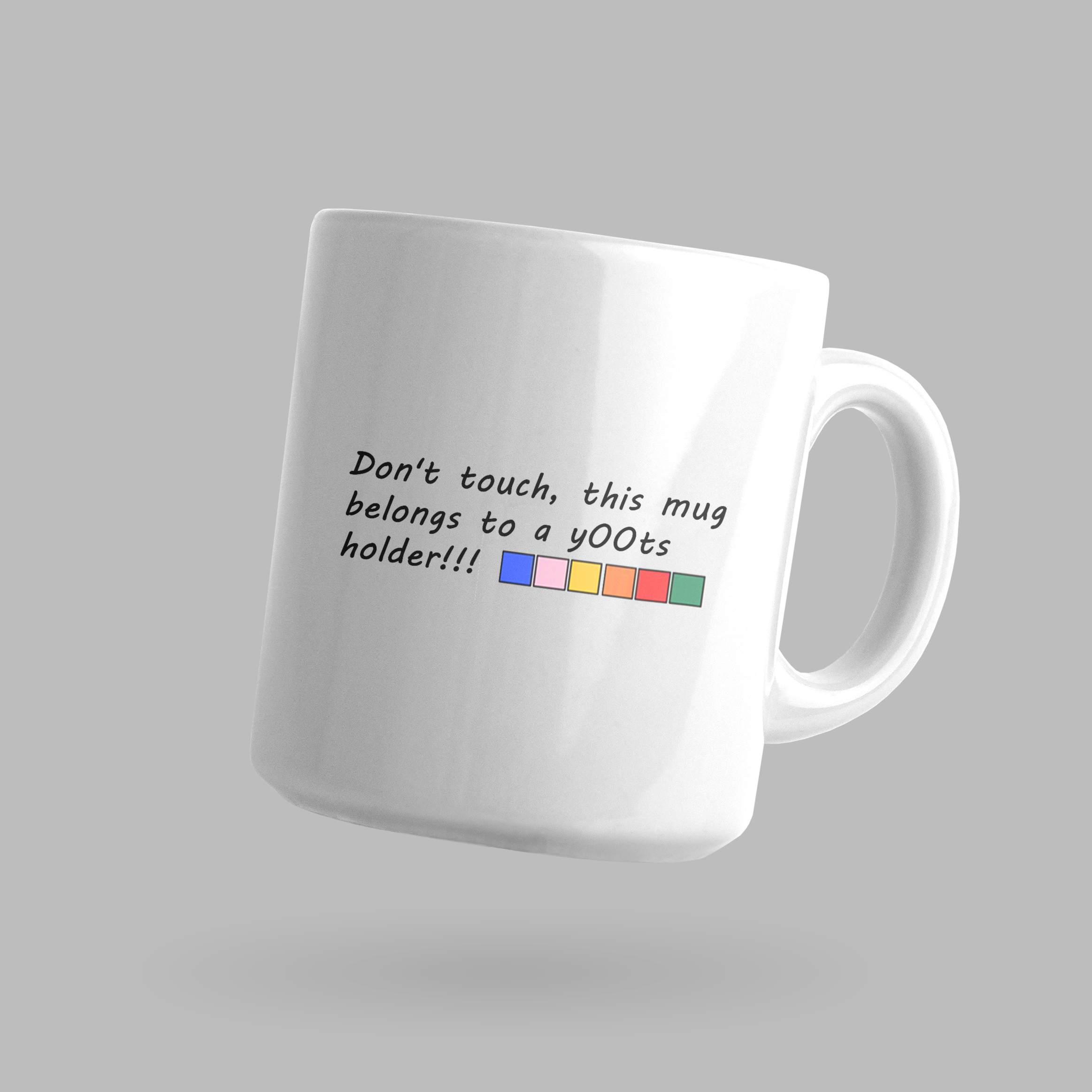 Front of tote bag with washed black canvas body, black straps, and tan leather handles and accents.