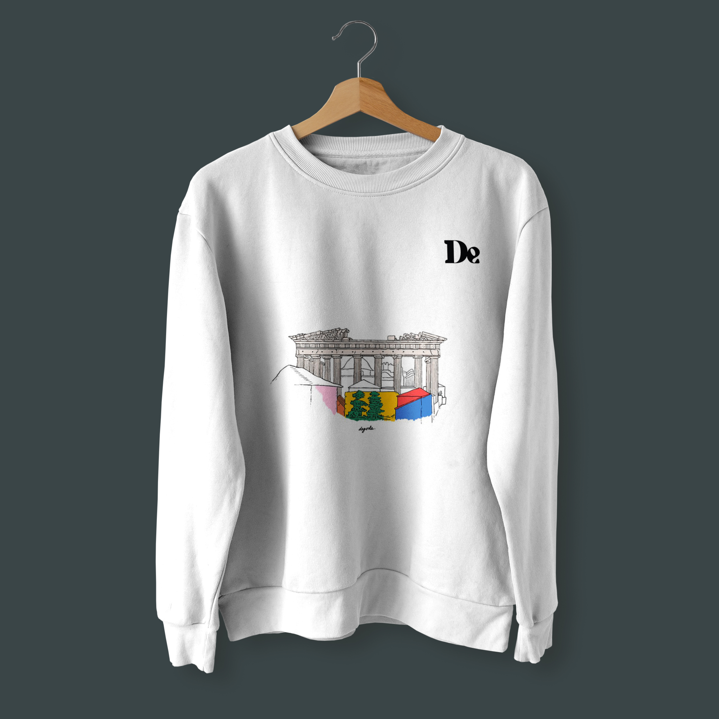 Front of tote bag with washed black canvas body, black straps, and tan leather handles and accents.