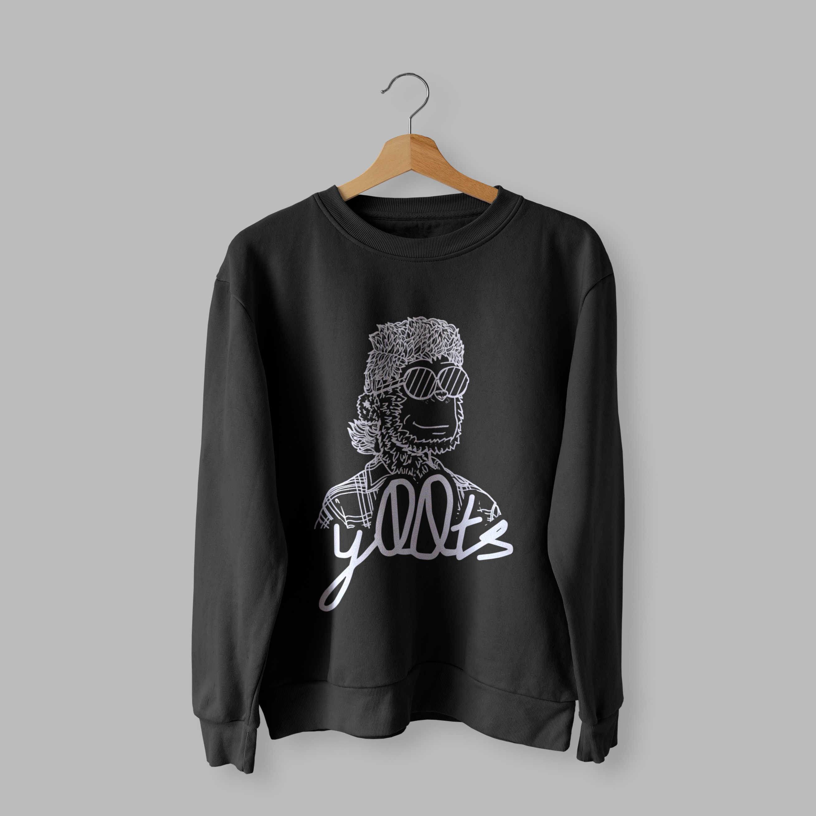 Front of tote bag with washed black canvas body, black straps, and tan leather handles and accents.