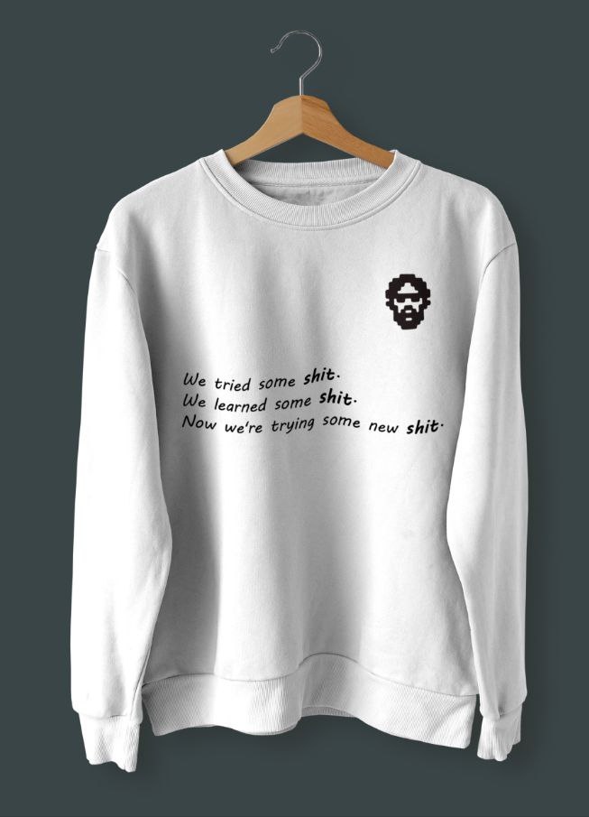 Front of tote bag with washed black canvas body, black straps, and tan leather handles and accents.