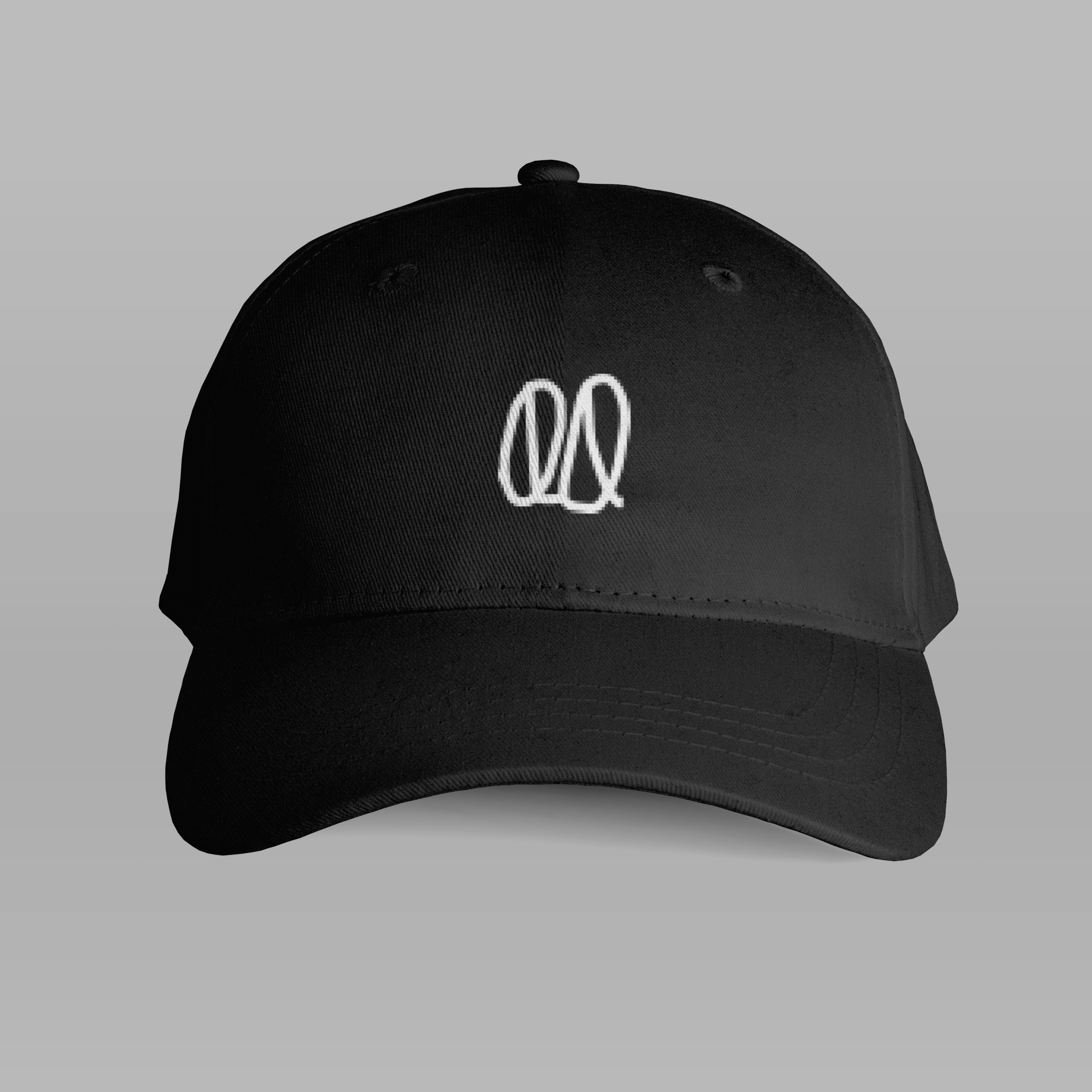 Front of tote bag with washed black canvas body, black straps, and tan leather handles and accents.