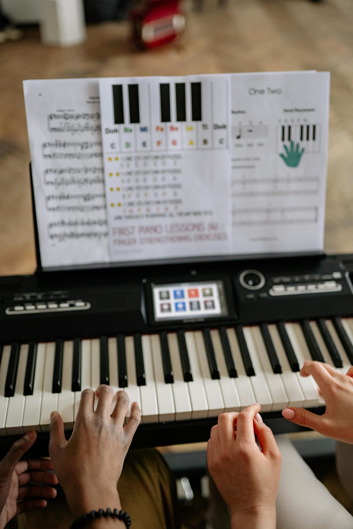 Adult beginner learning piano with sheet music open