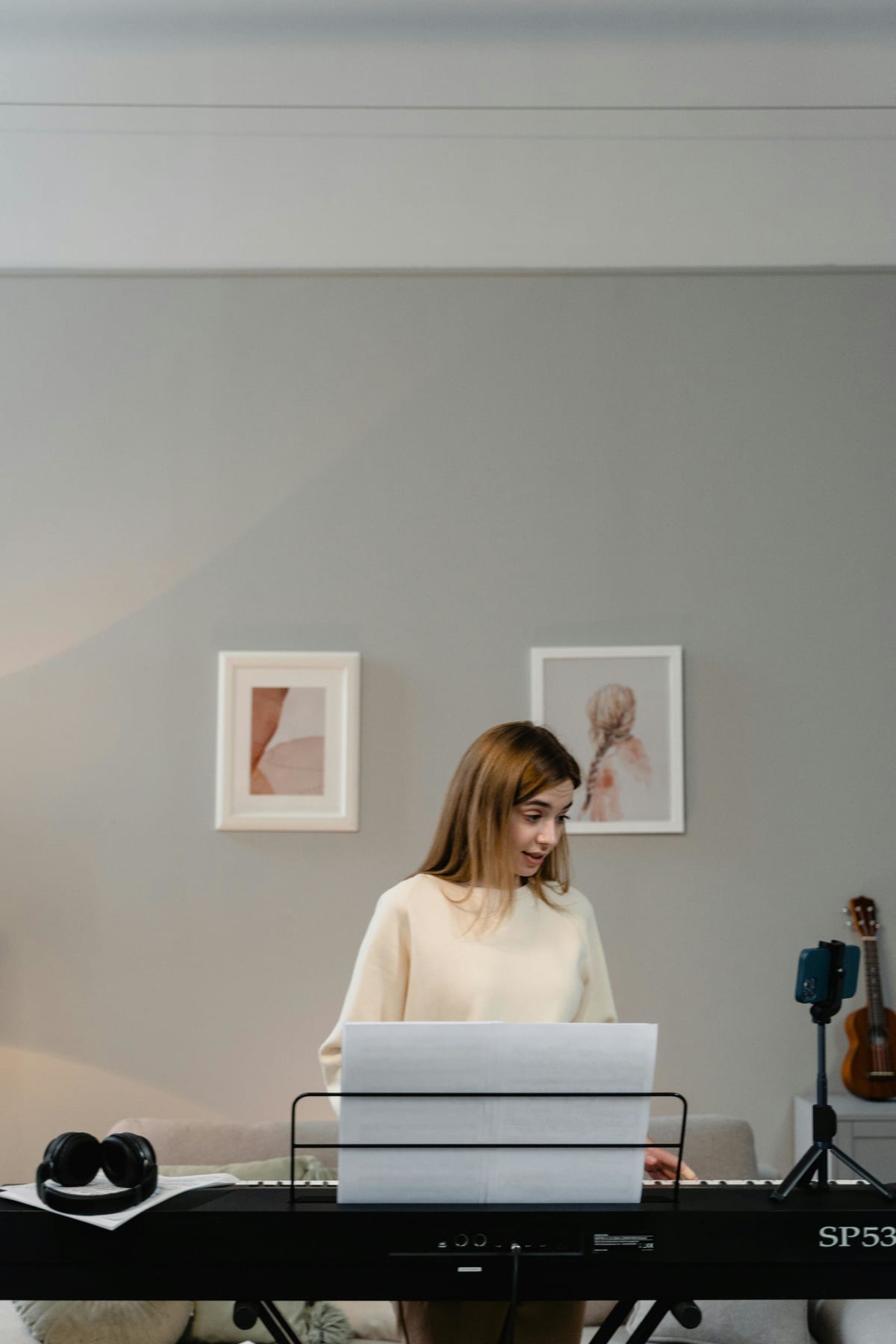 Adult practicing piano at home in a cozy room
