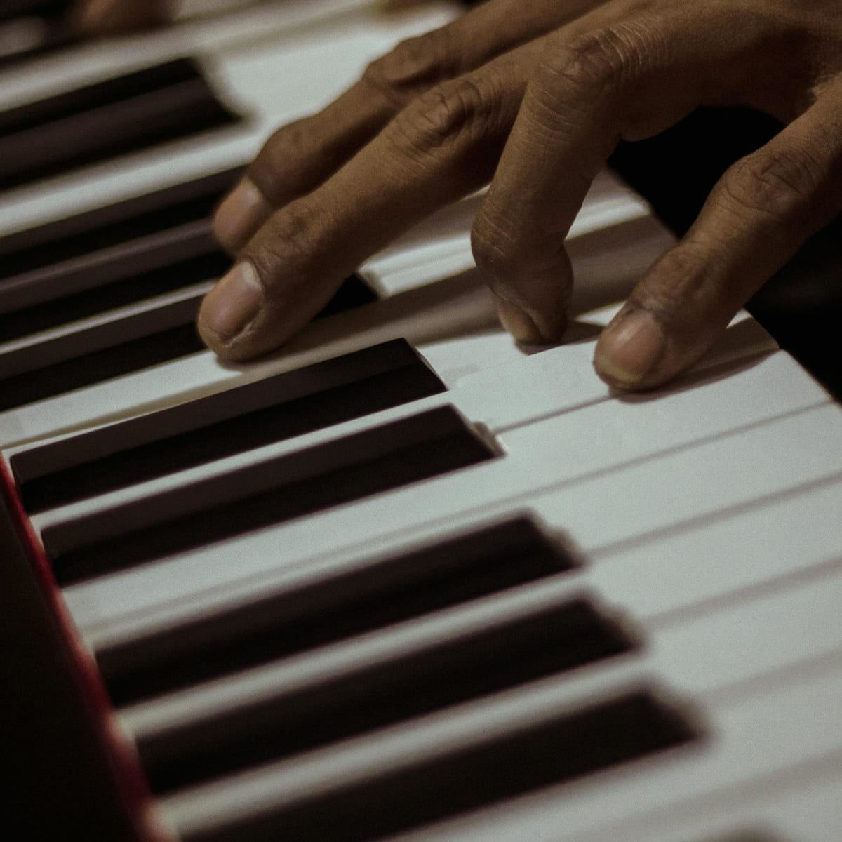 Close-up of hands playing a piano keyboard during focused practice