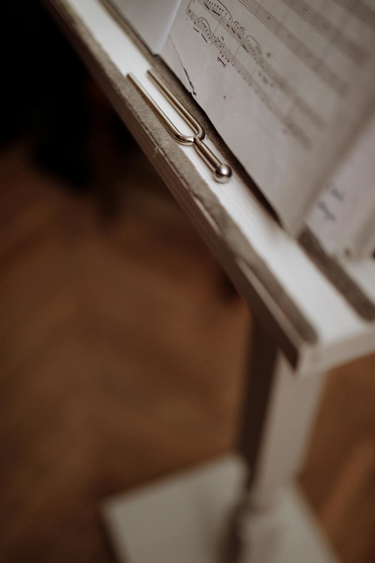 Tuning fork resting beside sheet music