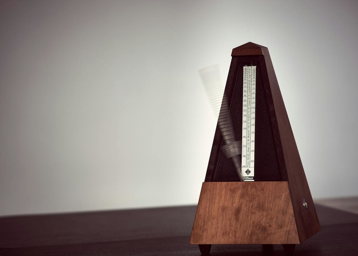 Close-up of a wooden metronome moving during music practice