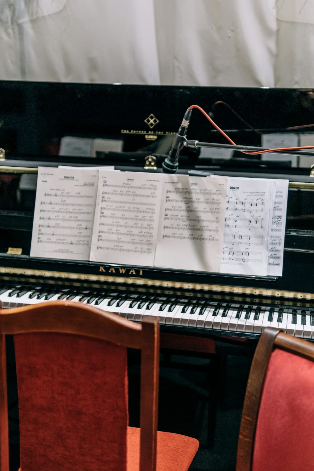 A piano with sheet music laid open, ready for a daily practice session