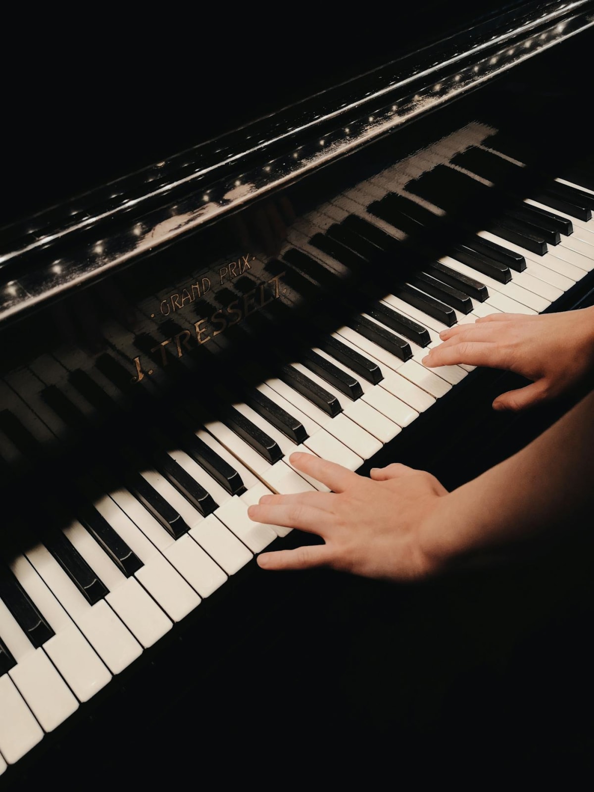 Adult learner working at the piano on a single focused passage