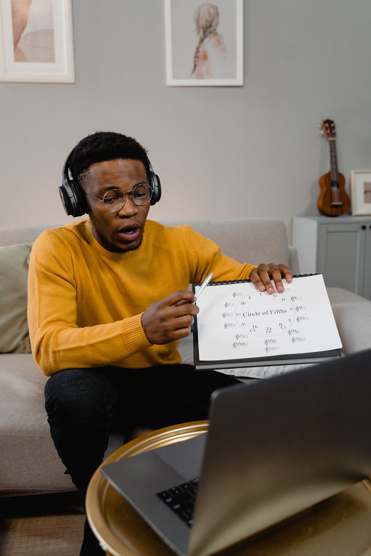An online piano teacher explaining the circle of fifths to a student over a laptop call