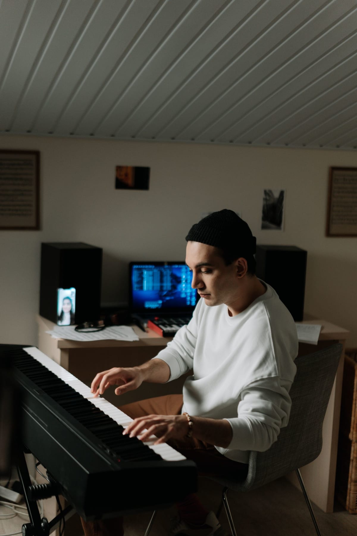 Pianist playing a slim digital piano in a compact home studio