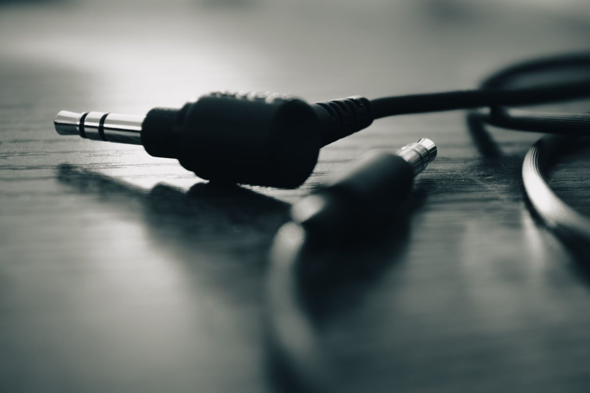 Close-up of a small 3.5 millimeter stereo audio plug with two insulating rings