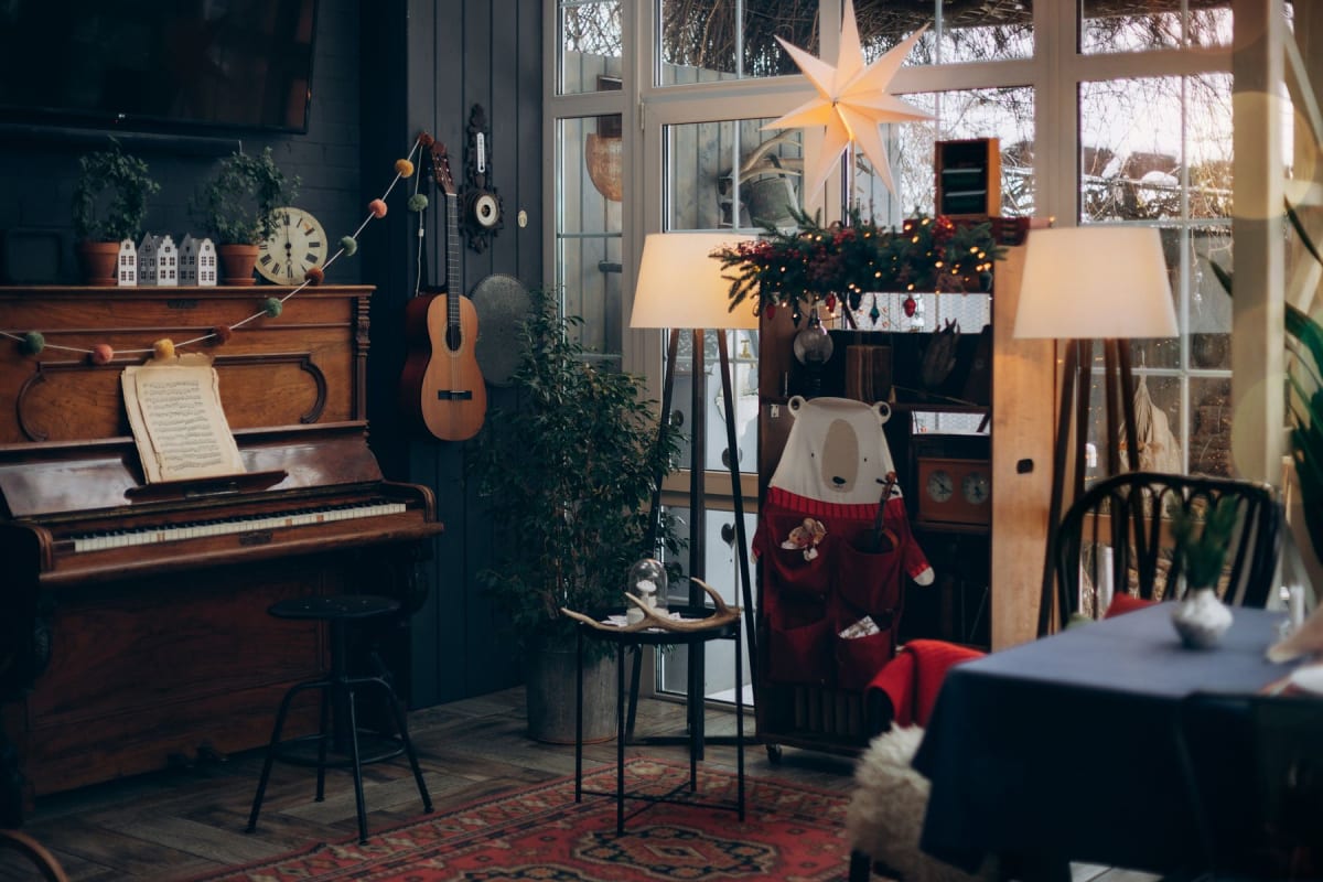 Upright piano with an open score in a furnished home practice room
