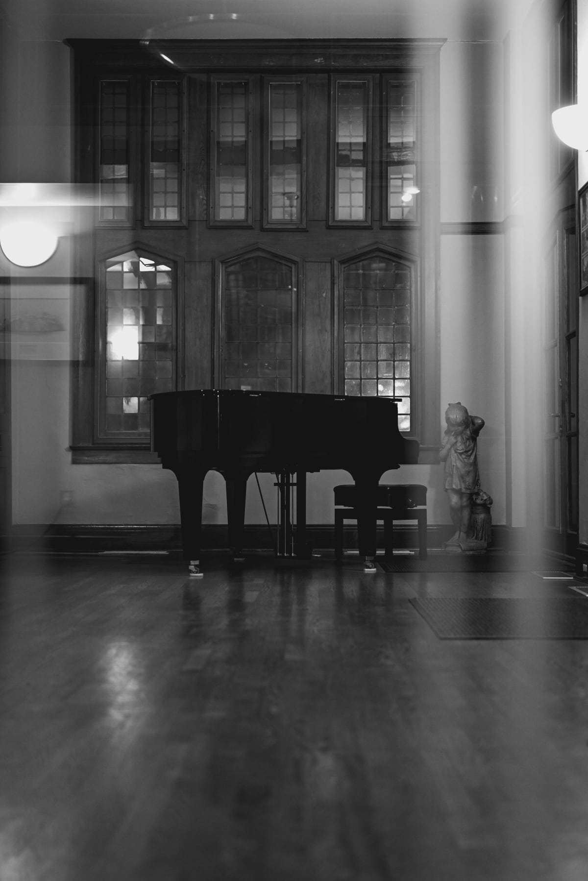 Grand piano in a quiet room by tall windows