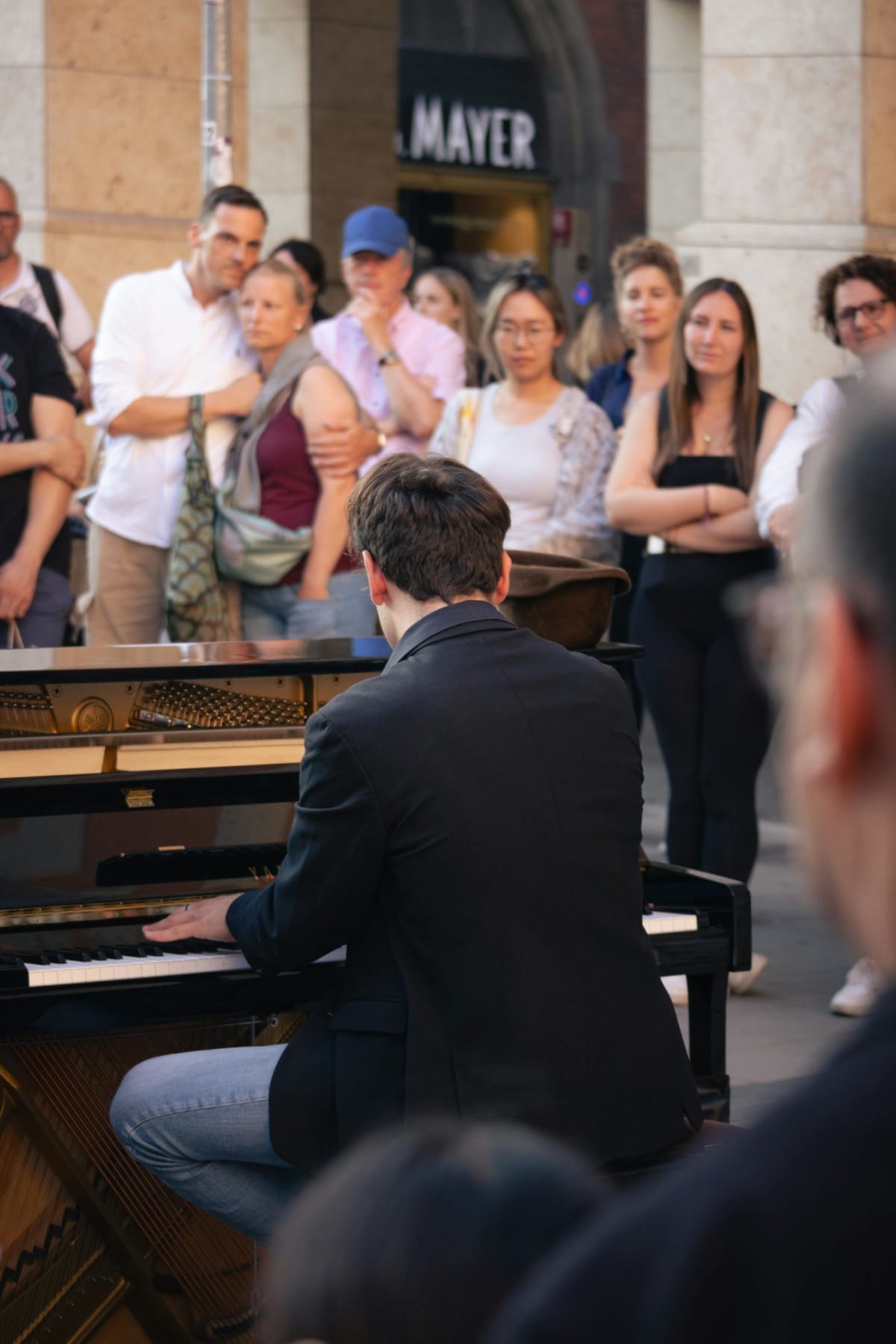 Pianist performing in front of a crowd outdoors