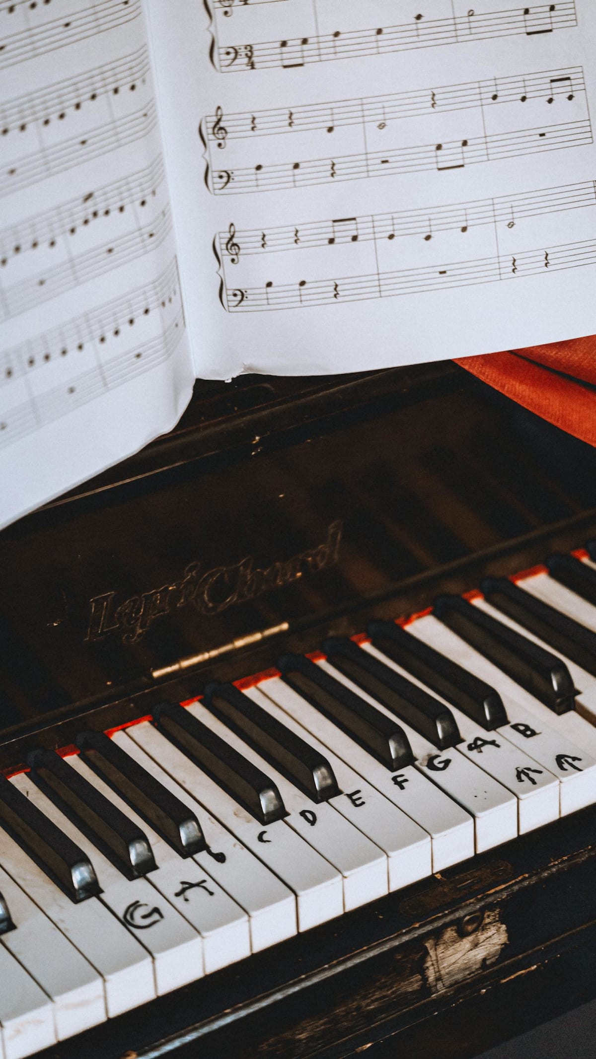 Close-up of piano keys and sheet music during score study