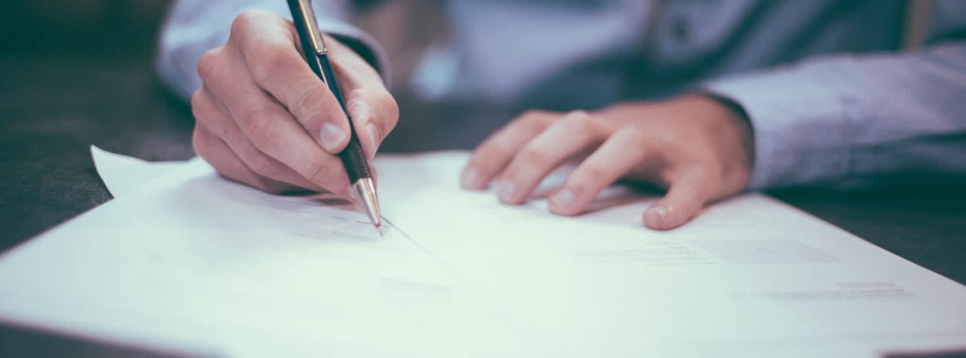 Person reviewing a creator brand deal contract at a desk