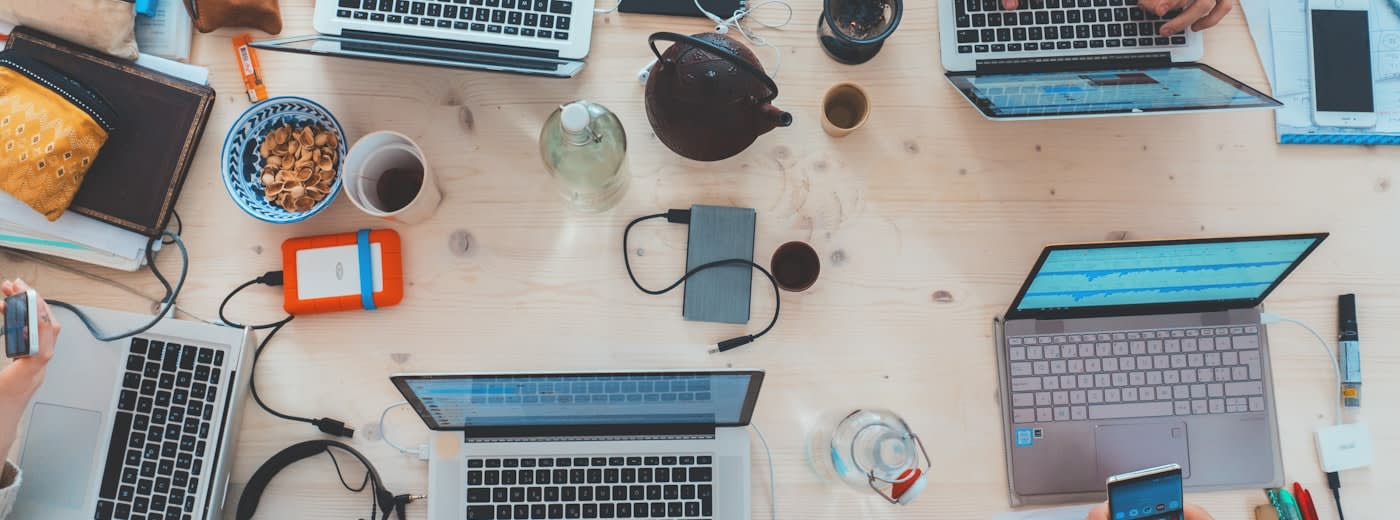 Young people collaborating on laptops  -  Gen Z student entrepreneurs and college startups