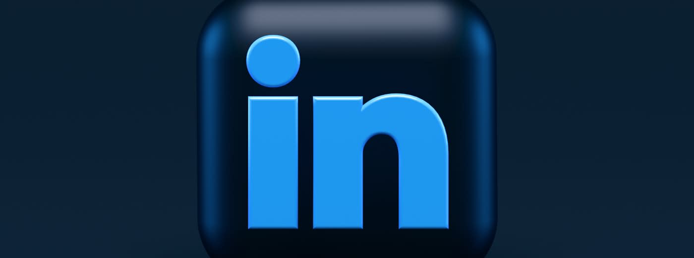 Professional working on laptop representing LinkedIn creator strategy and B2B personal branding