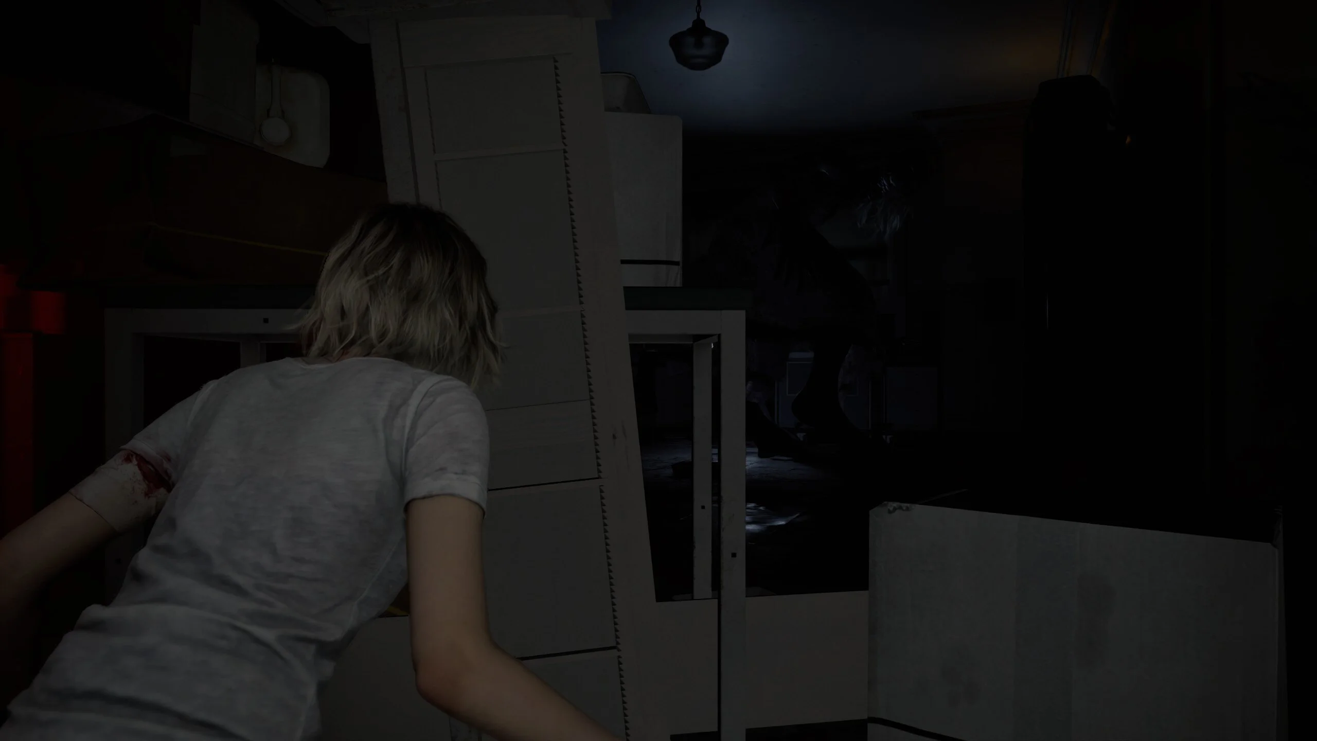 Grace Ashcroft hiding from the stalker in a dark room in Resident Evil Requiem