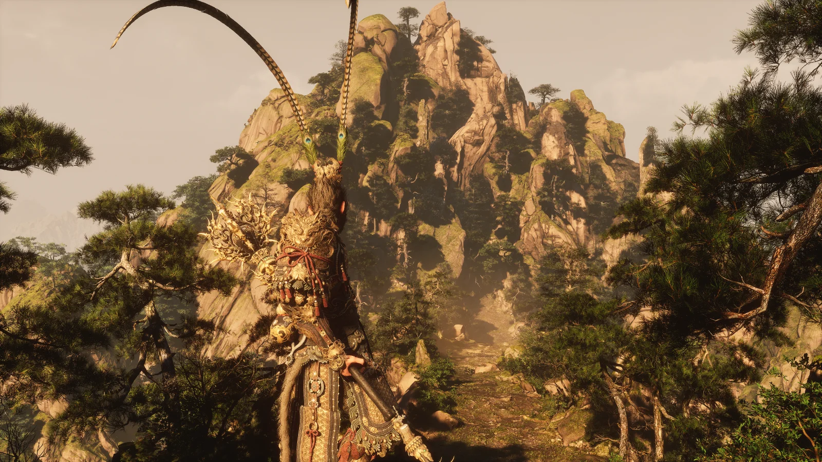 The Destined One overlooks a scenic mountain valley surrounded by towering cliffs and pine trees in Black Myth: Wukong.