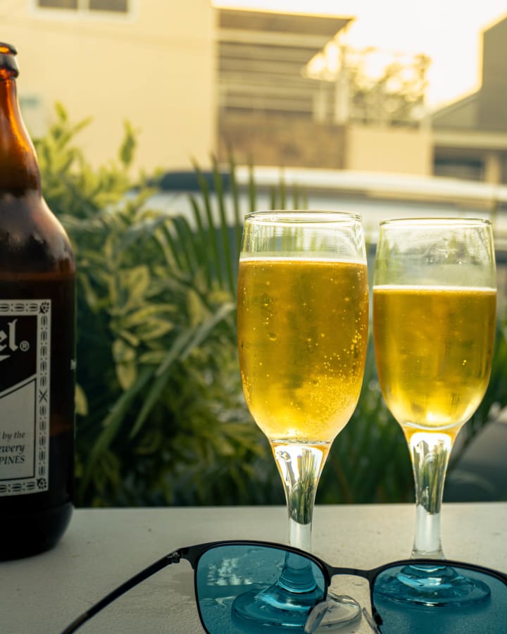Two glasses on a table in warm outdoor light