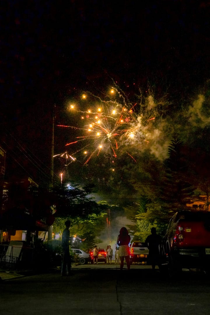Fireworks lighting up a quiet street at night