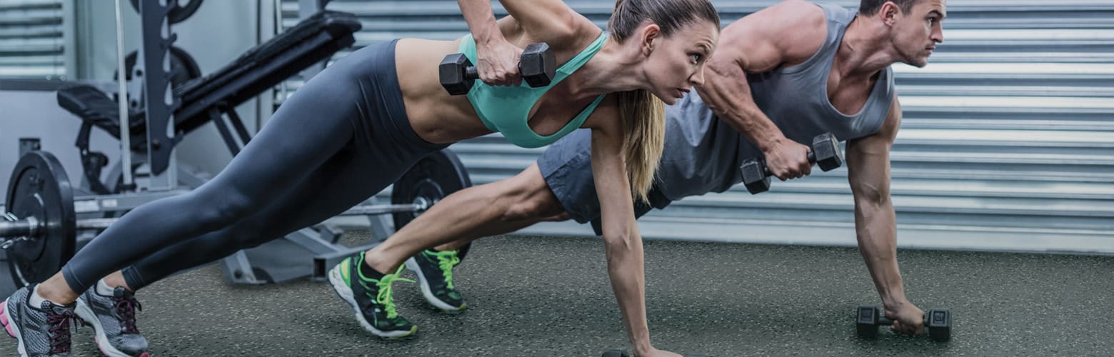 Woman and Man Working Out On Synthetic Gym Floor