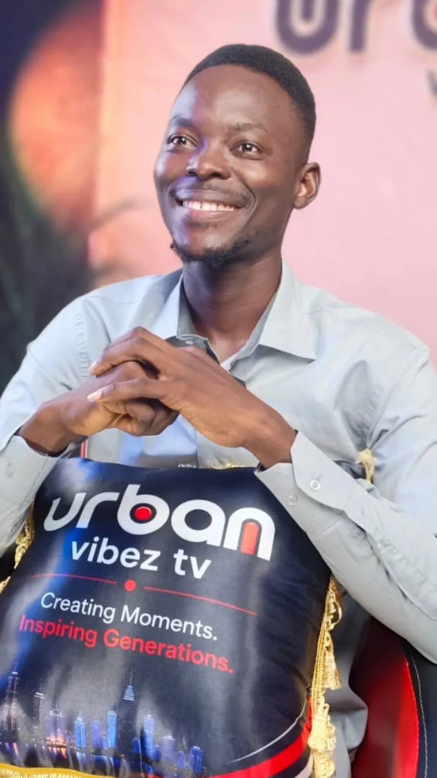 Guest holding a branded pillow on set