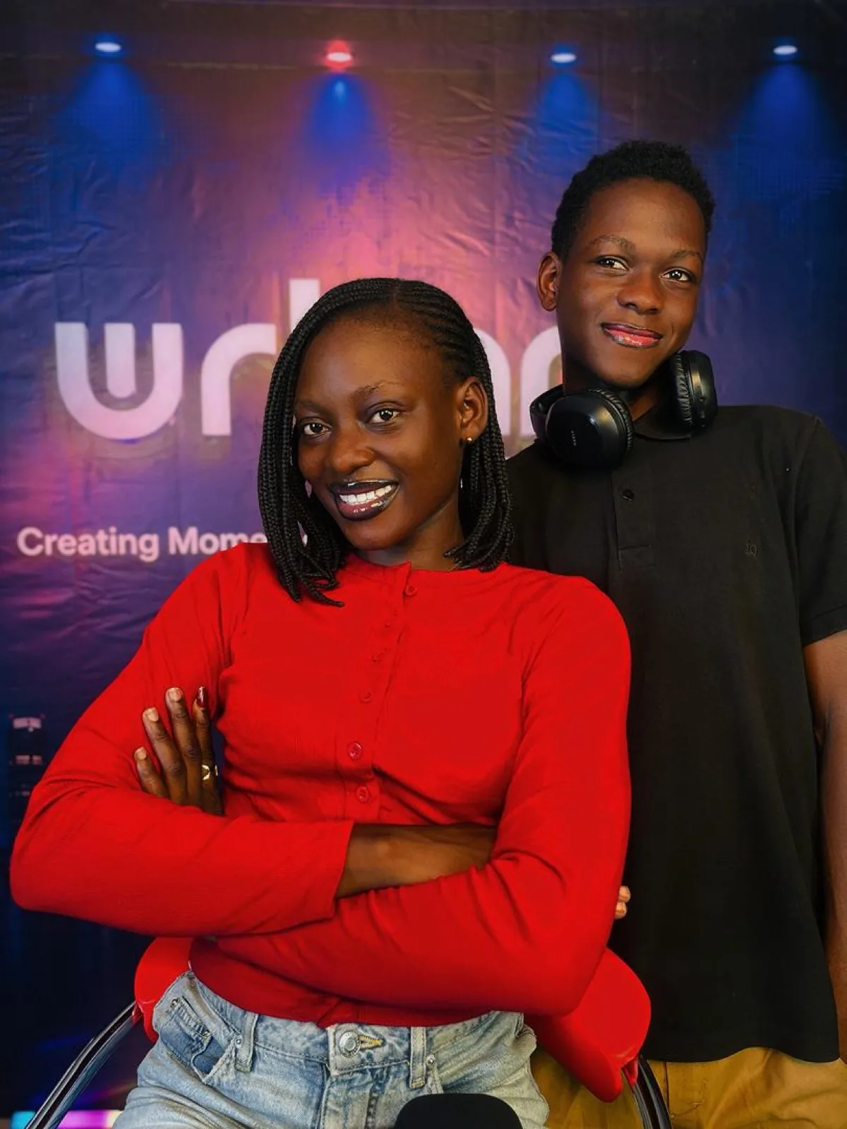 Two young hosts, one wearing headphones
