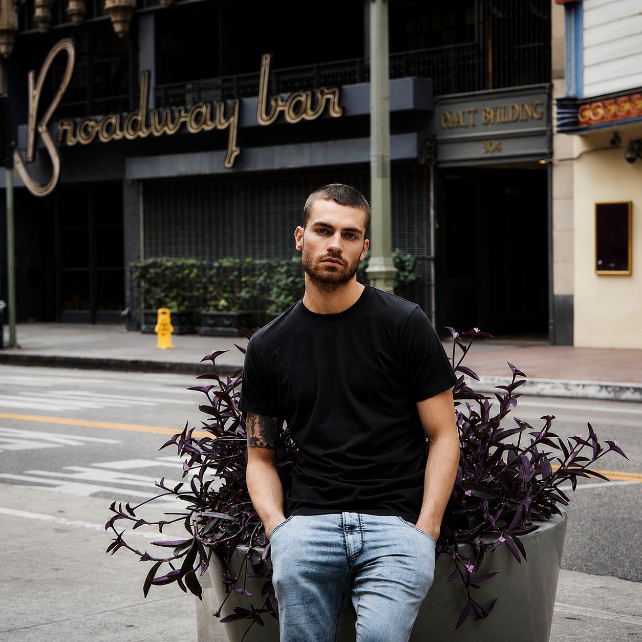 A man wearing a charcoal tee shirt