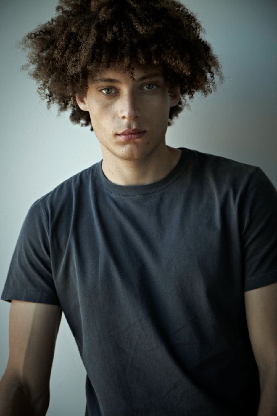 A man wearing a mocha t-shirt
