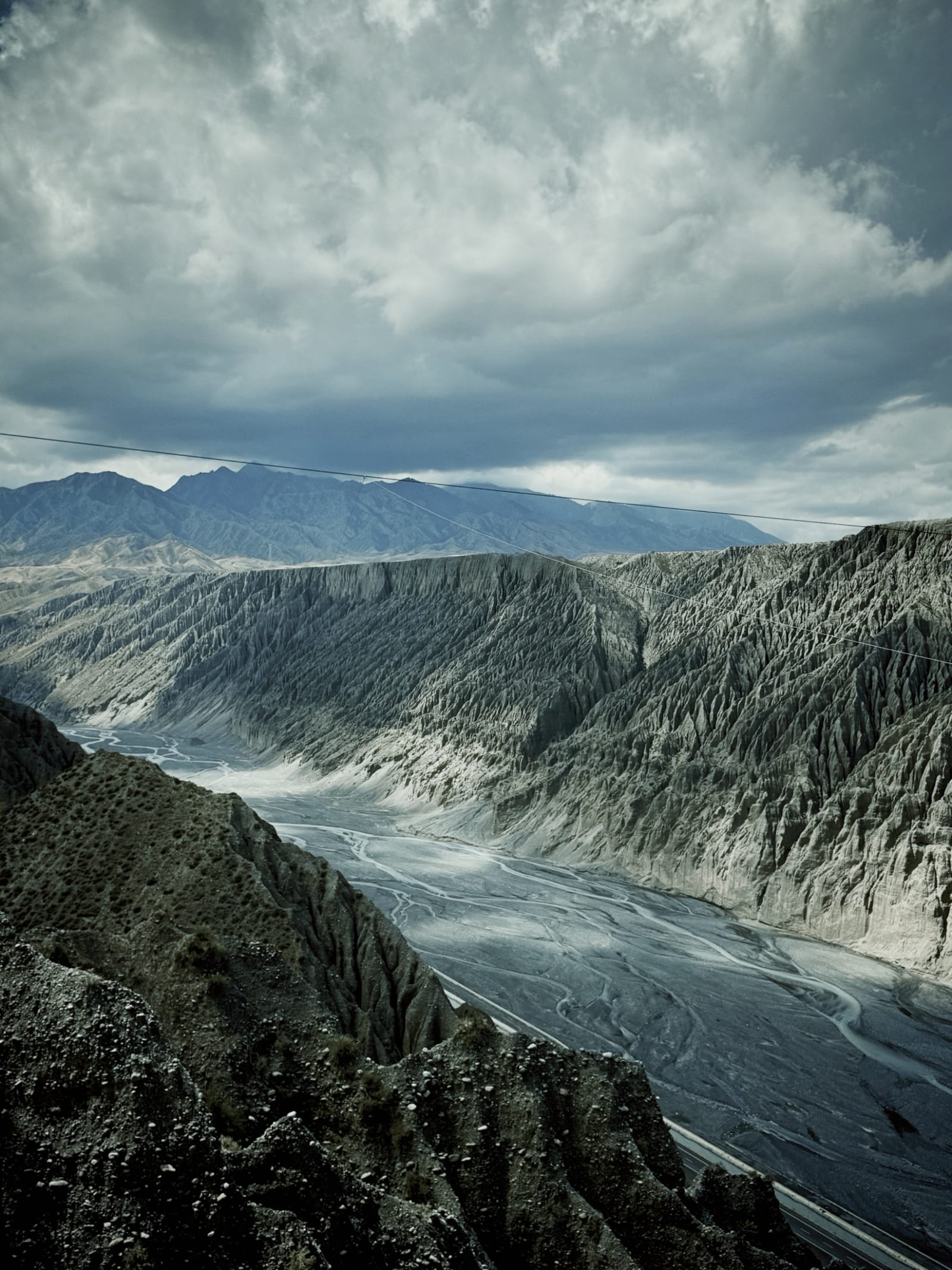 Wind-eroded desert ridges falling away in raking light